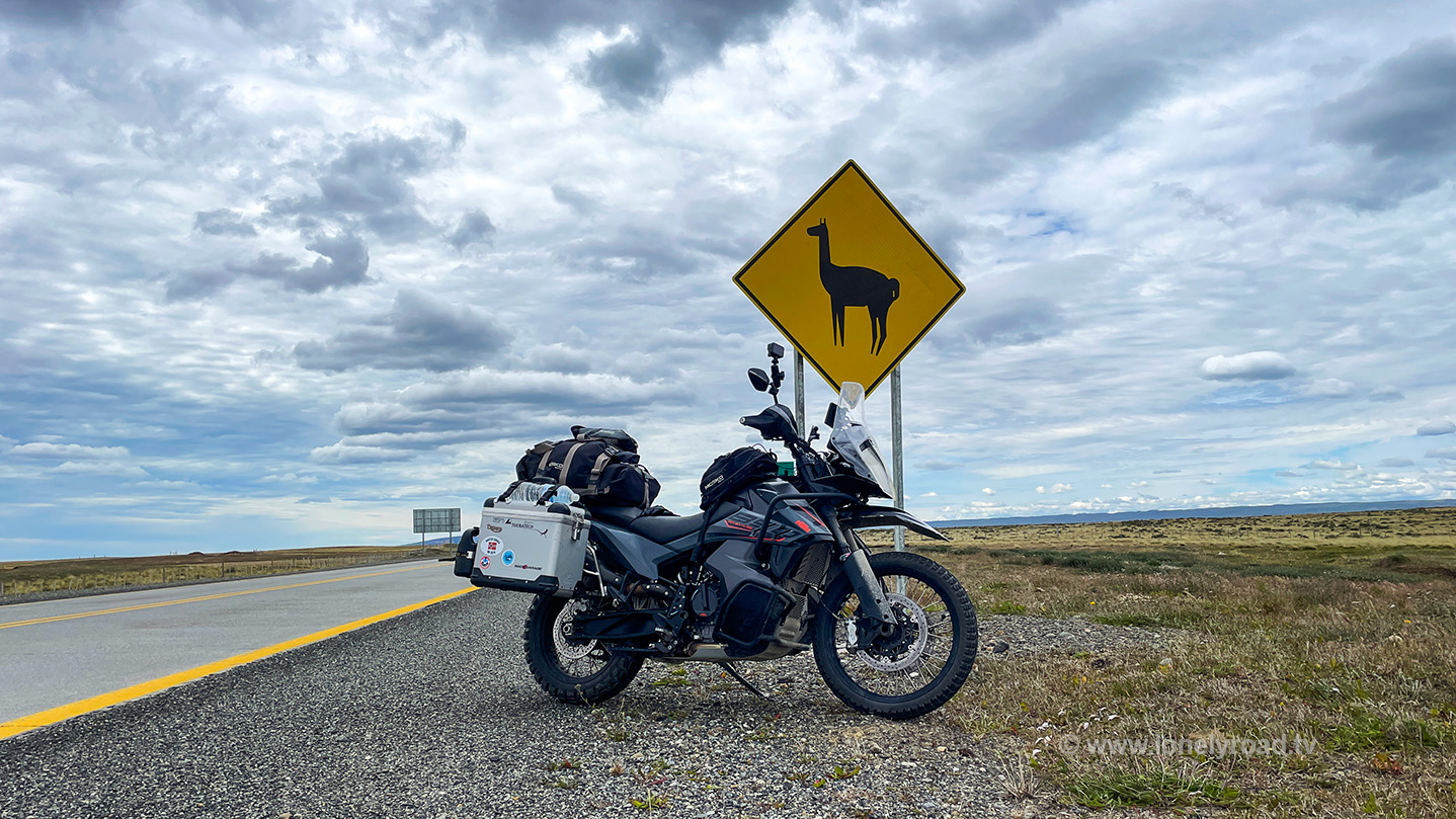 Motorcycle in front of a guanaco warning sign, Chile