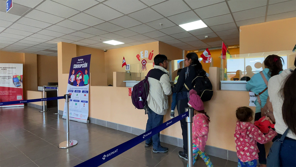 People waiting to be processed at the immigration desk