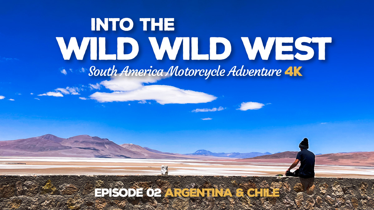 A photo of a person sitting on a small wall overlooking a vast high altitude desert in Chile