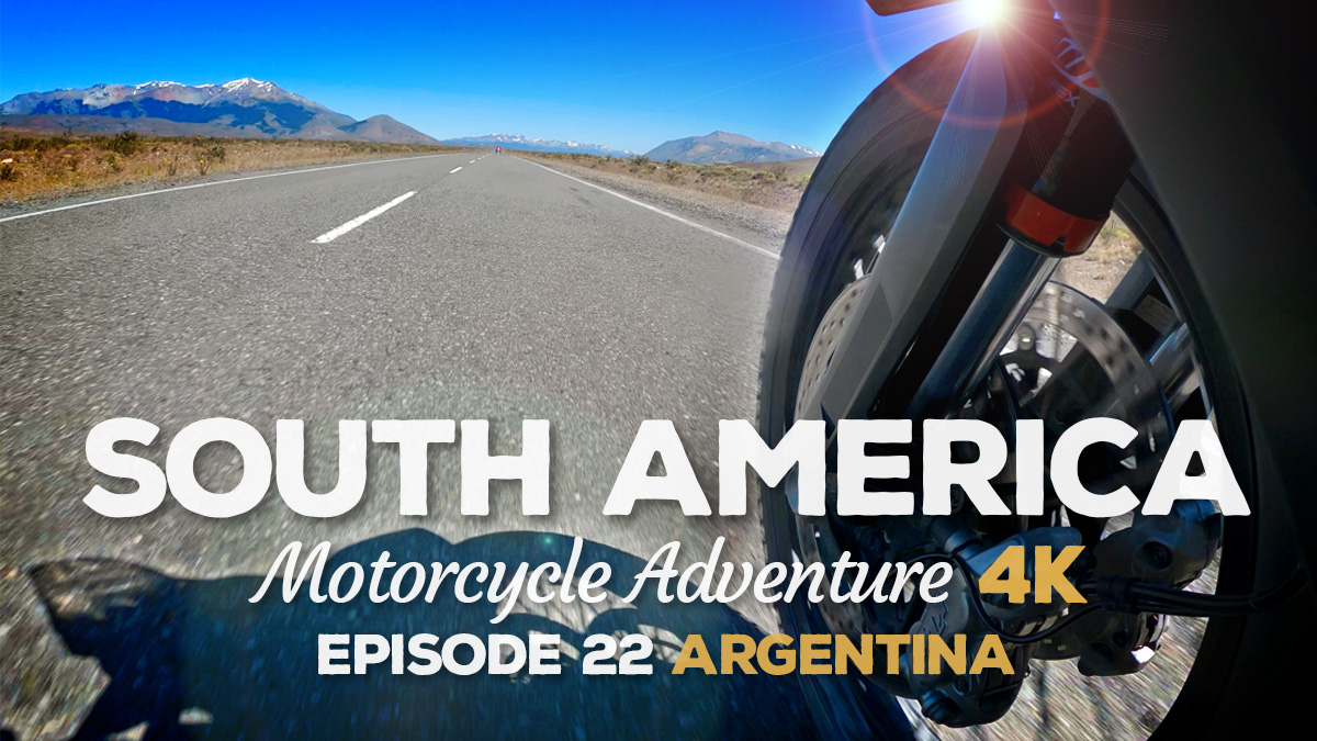 A low angle shot of a motorcycle wheel pointed towards some mountains on Ruta 40 in Argentina