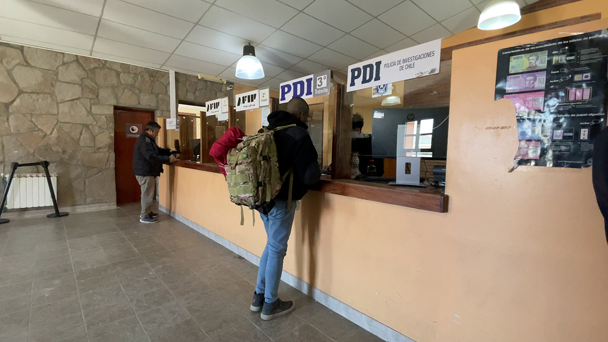 People standing at the first set of official counters for Paso de Jama border