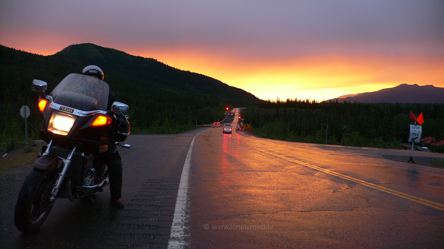 Sunset shot of man on a motorcycle in Alaska, USA